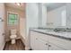 Bathroom with granite countertop, white cabinets, and vinyl flooring at 443 Creekwood Pass, Dallas, GA 30157
