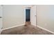 Well-lit bedroom with carpeted floor and door to another room at 4660 Edwina Sw Ln, Atlanta, GA 30331