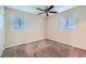 Well-lit bedroom with neutral carpeting and ceiling fan at 4660 Edwina Sw Ln, Atlanta, GA 30331
