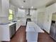 Bright kitchen with white cabinets, stainless steel appliances and hardwood floors at 2272 Misty Brook Ct, Buford, GA 30519