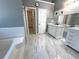 Main bathroom with double vanity, marble floors, and separate tub and shower at 300 Redford Trl, Stockbridge, GA 30281