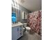 Clean bathroom with white vanity and floral shower curtain at 300 Redford Trl, Stockbridge, GA 30281