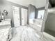 Spa-like bathroom with marble flooring and soaking tub at 300 Redford Trl, Stockbridge, GA 30281