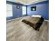 Spacious bedroom with blue walls and a king-size bed at 300 Redford Trl, Stockbridge, GA 30281