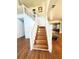 Elegant wooden staircase with white railings at 300 Redford Trl, Stockbridge, GA 30281