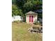 Charming backyard shed with red doors and white trim at 300 Redford Trl, Stockbridge, GA 30281