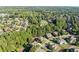 Aerial view of a neighborhood with houses surrounded by lush trees at 4070 Preserve Crossing Ln, Cumming, GA 30040