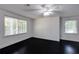 Well-lit bedroom featuring dark hardwood floors and two windows at 1664 Womack Rd, Dunwoody, GA 30338