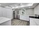 Modern basement kitchen with white cabinets and quartz countertops at 1664 Womack Rd, Dunwoody, GA 30338