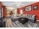 Spacious living room with gray sectional sofa and hardwood floors at 2608 Downing Park Se Dr, Conyers, GA 30094