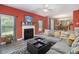 Living area features a gray sectional, fireplace, and hardwood floors at 2608 Downing Park Se Dr, Conyers, GA 30094