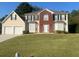 Two-story brick and siding house with a two-car garage and manicured lawn at 2608 Downing Park Se Dr, Conyers, GA 30094