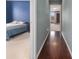 Hallway with dark brown hardwood floors connecting bedrooms at 2608 Downing Park Se Dr, Conyers, GA 30094