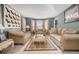 Elegant living room with bay window, plush sofas, and tasteful decor at 2608 Downing Park Se Dr, Conyers, GA 30094