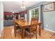 Dining room features a wood table and chairs, with views into the living room at 2608 Downing Park Se Dr, Conyers, GA 30094