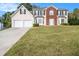 Two-story house with a two-car garage and a well-maintained lawn at 2608 Downing Park Se Dr, Conyers, GA 30094