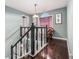 Upstairs hallway with dark hardwood floors and window seat at 2608 Downing Park Se Dr, Conyers, GA 30094