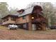 Back of house with large deck and hillside at 9955 S Helton Rd, Villa Rica, GA 30180