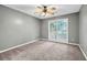 Well-lit bedroom featuring carpet and a large window at 2343 Benji Se Blvd, Conyers, GA 30013