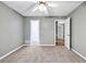 Bedroom with carpet, ceiling fan and access to closets at 2343 Benji Se Blvd, Conyers, GA 30013