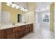 Double vanity bathroom with a separate shower and tile floors at 1243 Royal Ives Ct, Lawrenceville, GA 30045