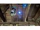 Unfinished attic space with exposed wooden beams, electrical wiring, and a hole in the ceiling at 879 Edwin Nw Pl, Atlanta, GA 30318
