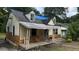 Fixer-upper house with damaged roof and siding at 879 Edwin Nw Pl, Atlanta, GA 30318