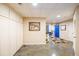 Long basement hallway with beige walls and blue doors at 2725 Florence Ann Ter, Buford, GA 30519