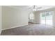 Spacious living room with carpet, ceiling fan and sliding glass door to patio at 2895 Springfield Ct, Atlanta, GA 30349
