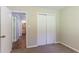 Bedroom with gray carpet, door to bathroom and double door closet at 2895 Springfield Ct, Atlanta, GA 30349