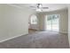Spacious living room with carpet, ceiling fan and sliding glass door to patio at 2895 Springfield Ct, Atlanta, GA 30349