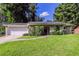 Brick ranch home with a white garage door and a landscaped yard at 2895 Springfield Ct, Atlanta, GA 30349
