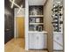 Modern entryway with built-in shelving, wine rack, and stylish hexagon tile at 400 W Peachtree Nw St # 1204, Atlanta, GA 30308