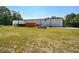 White metal building with large grassy area and equipment at 787 Tidwell Rd, Powder Springs, GA 30127