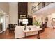 Living room with hardwood floors, high ceilings, and a fireplace at 787 Tidwell Rd, Powder Springs, GA 30127