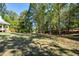 Landscaped backyard with lush greenery and tall trees at 787 Tidwell Rd, Powder Springs, GA 30127