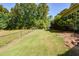 Landscaped side yard with chain link fence at 787 Tidwell Rd, Powder Springs, GA 30127