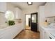 Laundry room with white cabinets, tile floor and exterior access at 787 Tidwell Rd, Powder Springs, GA 30127