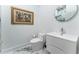 Modern bathroom with white vanity, toilet and marble floors at 3915 Muirfield Sq, Duluth, GA 30096