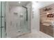 Elegant shower with marble tile and glass enclosure at 3915 Muirfield Sq, Duluth, GA 30096