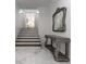 Elegant staircase with marble flooring and ornate console table at 3915 Muirfield Sq, Duluth, GA 30096
