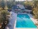 Community pool with lounge chairs and adjacent clubhouse at 3915 Muirfield Sq, Duluth, GA 30096