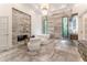 Spacious bathroom with marble floors, freestanding tub, and fireplace at 3915 Muirfield Sq, Duluth, GA 30096