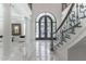 View from the foyer, showcasing the curved staircase and marble flooring at 3915 Muirfield Sq, Duluth, GA 30096