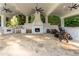 Large covered patio with outdoor kitchen, fireplace, and ceiling fans at 3915 Muirfield Sq, Duluth, GA 30096