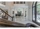 Spacious foyer with marble floors, grand staircase, and classical columns at 3915 Muirfield Sq, Duluth, GA 30096