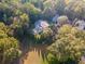 Aerial view showcasing home's private backyard and wooded surroundings at 3915 Muirfield Sq, Duluth, GA 30096