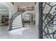 Elegant marble staircase with wrought iron railing and under-stair lighting at 3915 Muirfield Sq, Duluth, GA 30096