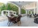 Large covered patio with seating area and views of the backyard at 3915 Muirfield Sq, Duluth, GA 30096