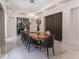Elegant dining room featuring a long table, marble floors, and a wood accent wall at 3915 Muirfield Sq, Duluth, GA 30096
